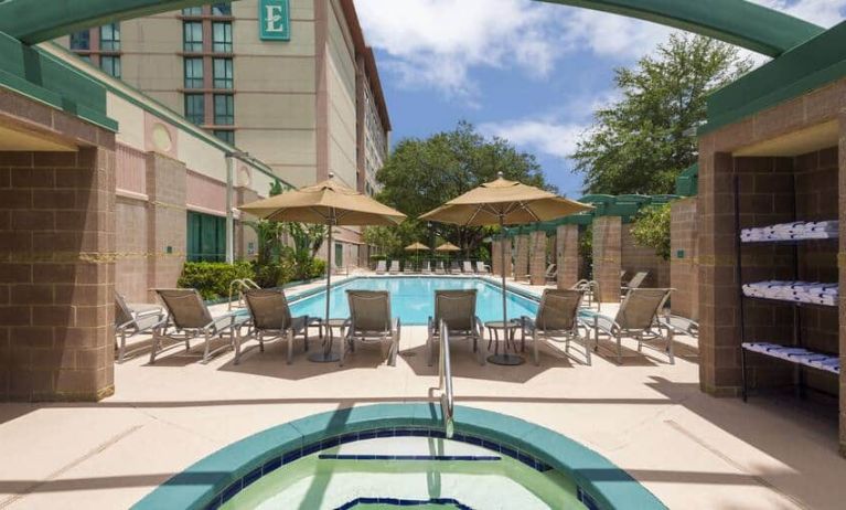 Beauitful outdoor pool with pool chairs and small jacuzzi at the Embassy Suites by Hilton Tampa USF