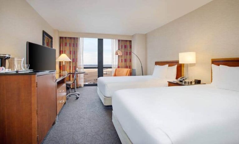 Spacious room with two queen beds,soundproof windows, chairs at the Hilton Chicago O'Hare Airport