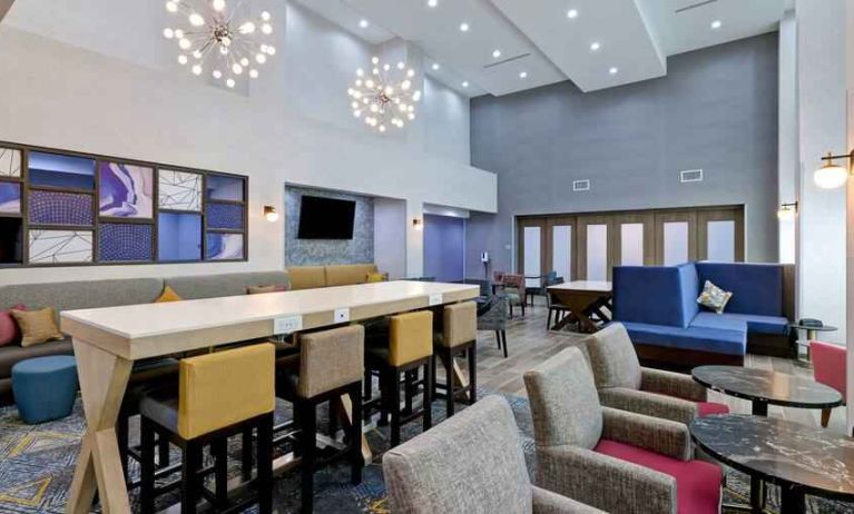 Workspace with chairs and sofas at the Hampton Inn & Suites Houston East Beltway 8.