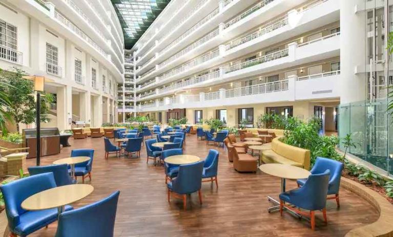 Beautiful and bright outdoor workspace with sofas and chairs at the Embassy Suites by Hilton Alexandria-Old Town.