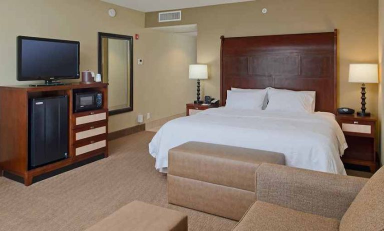 Spacious king-sized room with TV and mini-bar at Hampton Inn & Suites Ocean City/Bayfront-Convention Center.