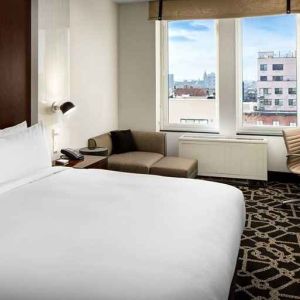 king-sized bed with desk at Hilton Brooklyn New York.