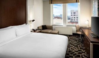 king-sized bed with desk at Hilton Brooklyn New York.