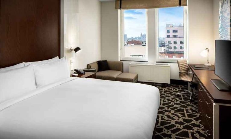 king-sized bed with desk at Hilton Brooklyn New York.