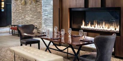 Elegant and comfortable fireside dining area perfect as workspace at the Hilton Denver City Center.