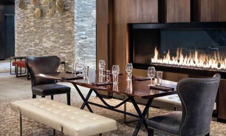 Elegant and comfortable fireside dining area perfect as workspace at the Hilton Denver City Center.