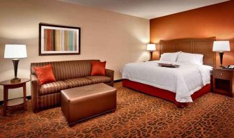 spacious king-sized bed with lounge area at Hampton Inn Omaha/West-Dodge Road (Old Mill).