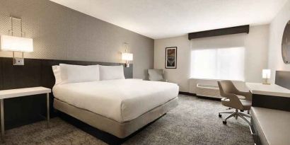 Cozy king bedroom with work desk at Hilton Garden Inn Washington DC Downtown.