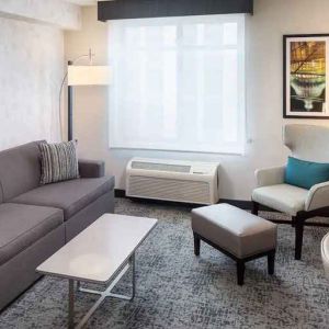 Bright-lit living area inside day use room at Hilton Garden Inn Washington DC Downtown.