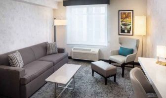 Bright-lit living area inside day use room at Hilton Garden Inn Washington DC Downtown.