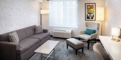 Bright-lit living area inside day use room at Hilton Garden Inn Washington DC Downtown.