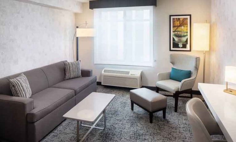 Bright-lit living area inside day use room at Hilton Garden Inn Washington DC Downtown.