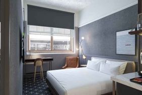 king bed with desk and all amenities at The Slate Denver, Tapestry Collection by Hilton.