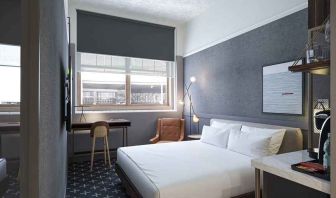 king bed with desk and all amenities at The Slate Denver, Tapestry Collection by Hilton.