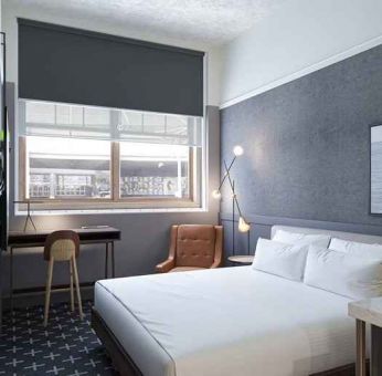 king bed with desk and all amenities at The Slate Denver, Tapestry Collection by Hilton.