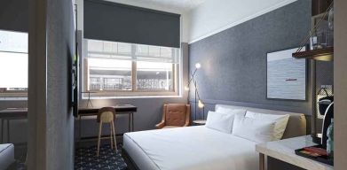 king bed with desk and all amenities at The Slate Denver, Tapestry Collection by Hilton.