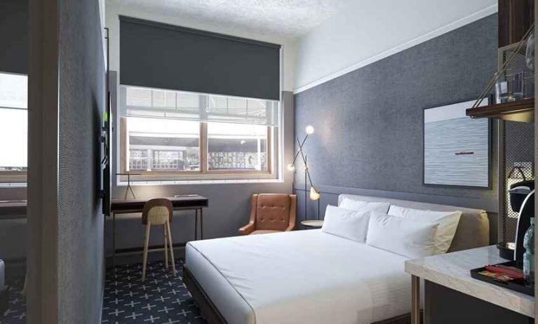 king bed with desk and all amenities at The Slate Denver, Tapestry Collection by Hilton.