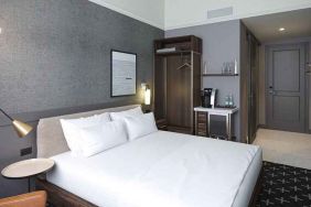 king bed with desk and all amenities at The Slate Denver, Tapestry Collection by Hilton.