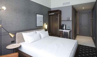 king bed with desk and all amenities at The Slate Denver, Tapestry Collection by Hilton.