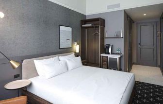 king bed with desk and all amenities at The Slate Denver, Tapestry Collection by Hilton.