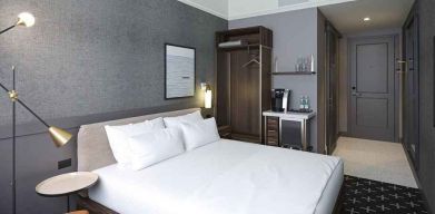 king bed with desk and all amenities at The Slate Denver, Tapestry Collection by Hilton.