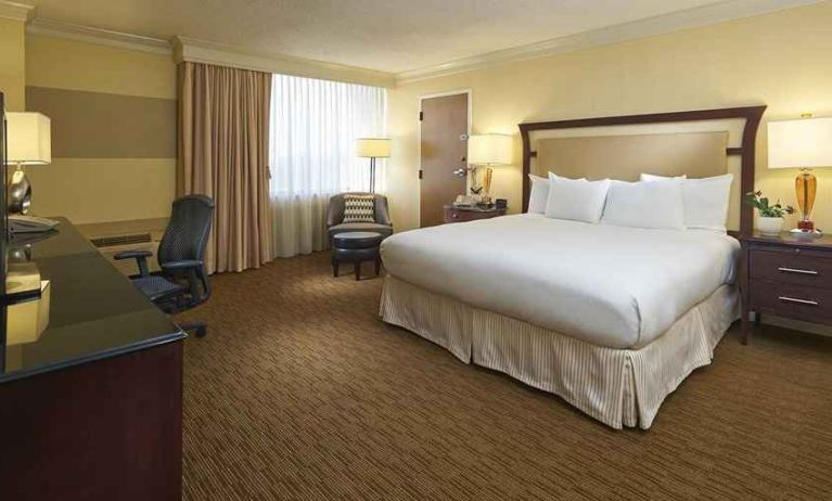 spacious king room equipped with work desk and natural light at Hilton Raleigh North Hills.