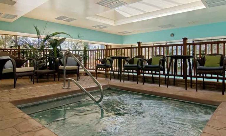 small indoor pool with comfortable social seating area at Hilton Raleigh North Hills.