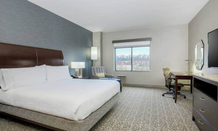 Spacious king size suite with 1 king bed, desk. and chairs at the the Hilton Garden Inn Arlington Shirlington