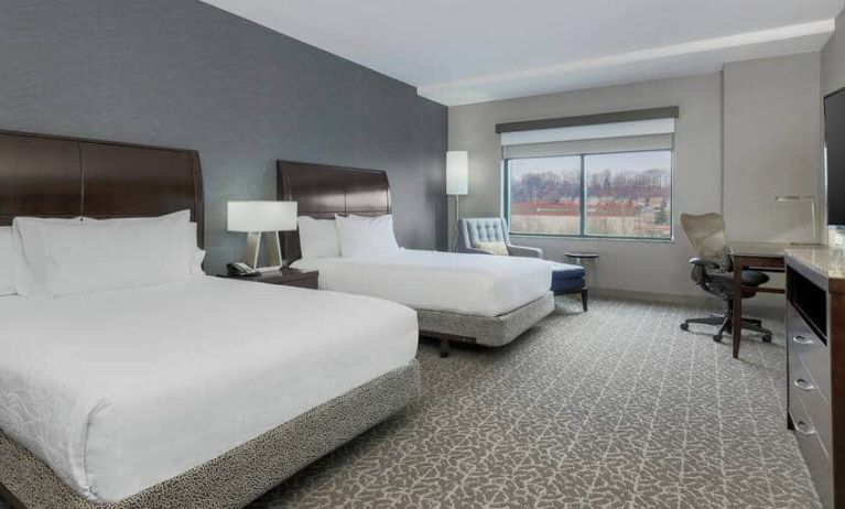 Spacious suite with 2 queen beds, chairs and desk set up at the Hilton Garden Inn Arlington Shirlington