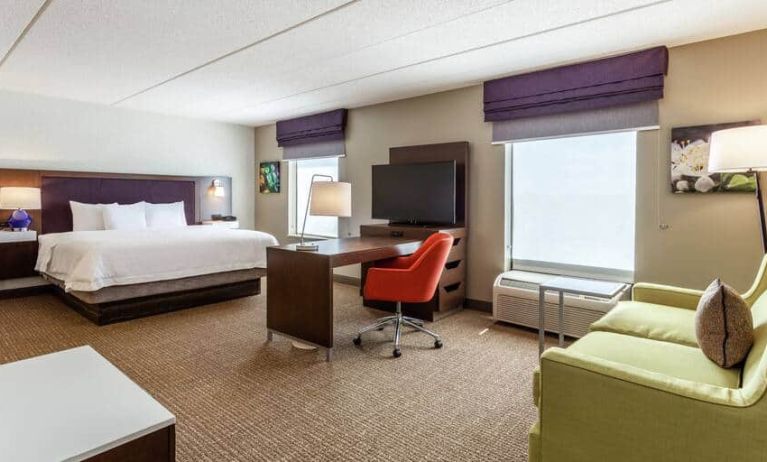 King suite with 1 king bed, couch, desks and tv at the Hampton Inn & Suites Chicago-Libertyville