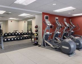Fitness center with treadmills and weights at the DoubleTree Suites by Hilton Detroit Downtown - Fort Shelby.