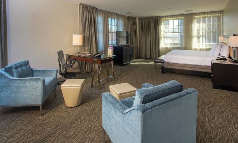 Great presidential bedroom with king bed and living room at the DoubleTree Suites by Hilton Detroit Downtown - Fort Shelby.