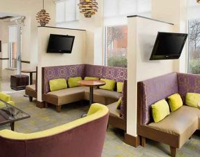 Bright lobby area perfect for small group meetings appointment at the Hilton Garden Inn Hartford North/Bradley Intl Airport.
