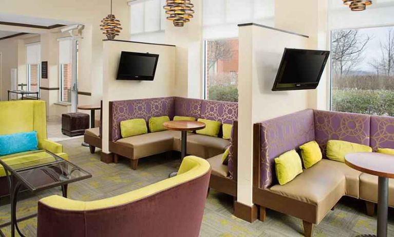 Bright lobby area perfect for small group meetings appointment at the Hilton Garden Inn Hartford North/Bradley Intl Airport.