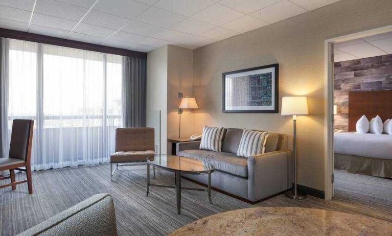 Living room with sofa and working station at the DoubleTree Suites by Hilton Houston by the Galleria.