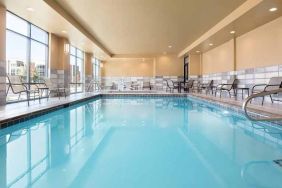 brigh-lit indoor pool with seating area at Hampton Inn Salt Lake City Cottonwood.