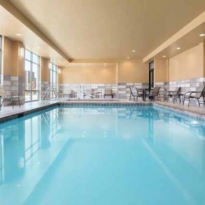 brigh-lit indoor pool with seating area at Hampton Inn Salt Lake City Cottonwood.