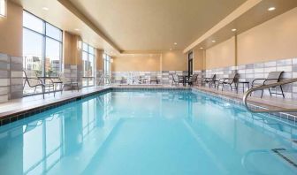 brigh-lit indoor pool with seating area at Hampton Inn Salt Lake City Cottonwood.