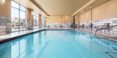 brigh-lit indoor pool with seating area at Hampton Inn Salt Lake City Cottonwood.