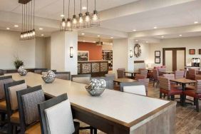 bright-lit lobby and coworking space with natural light and a variety of seating at Hampton Inn Salt Lake City Cottonwood.