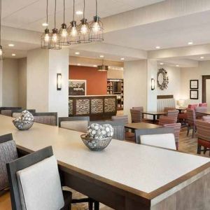 bright-lit lobby and coworking space with natural light and a variety of seating at Hampton Inn Salt Lake City Cottonwood.