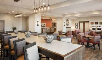 bright-lit lobby and coworking space with natural light and a variety of seating at Hampton Inn Salt Lake City Cottonwood.