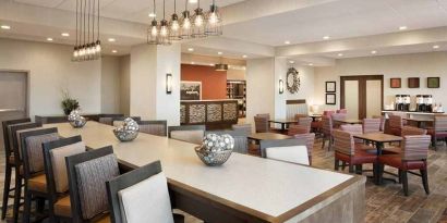 bright-lit lobby and coworking space with natural light and a variety of seating at Hampton Inn Salt Lake City Cottonwood.