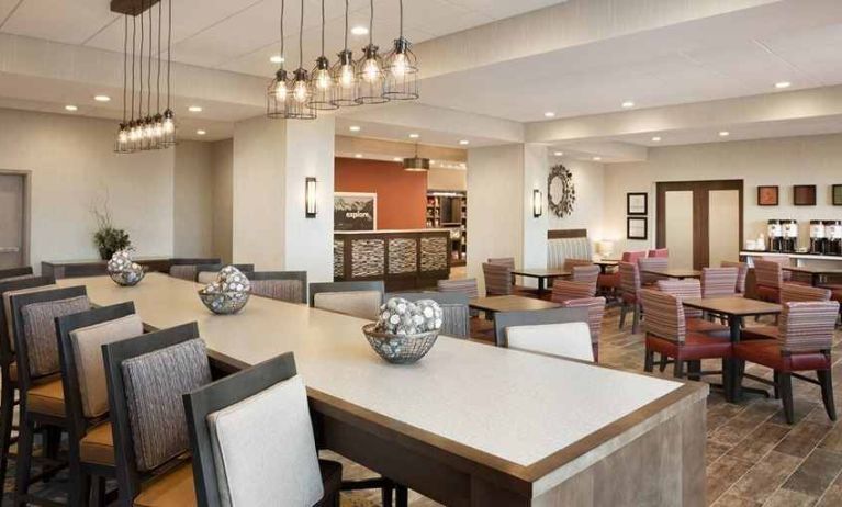 bright-lit lobby and coworking space with natural light and a variety of seating at Hampton Inn Salt Lake City Cottonwood.