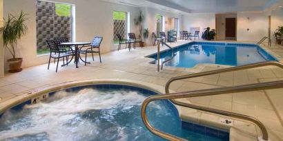 Relaxing indoor pool area with whirlpool at the Hilton Garden Inn Clarksburg.