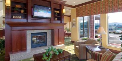 Elegant lobby area with fireplace and TV at the Hilton Garden Inn Clarksburg.