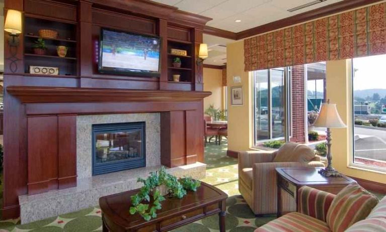 Elegant lobby area with fireplace and TV at the Hilton Garden Inn Clarksburg.