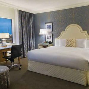 King size bed, large window and desk in a hotel room at the Hilton Dallas Lincoln Centre.