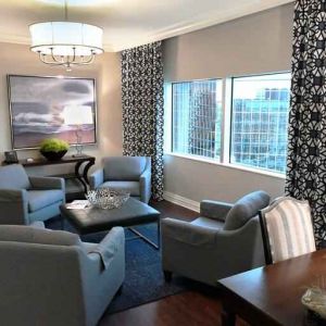 Comfortable and spacious living room with working station in a presidential suite at the Hilton Dallas Lincoln Centre.