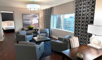 Comfortable and spacious living room with working station in a presidential suite at the Hilton Dallas Lincoln Centre.